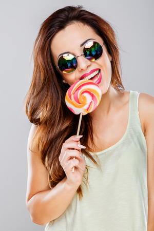 Beautiful girl with big colorful candyの写真素材