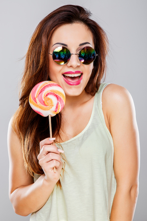 Girl with big colorful candyの写真素材