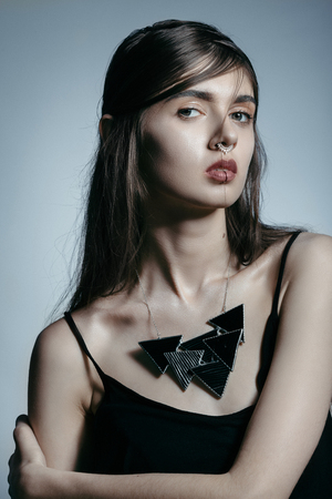 Girl with piercing and black necklaceの写真素材
