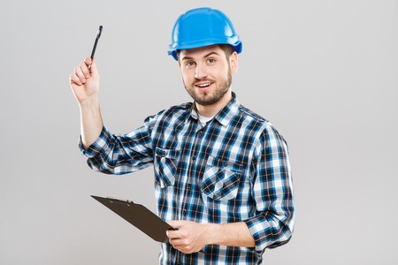 Builder holding tablet and raised penの写真素材