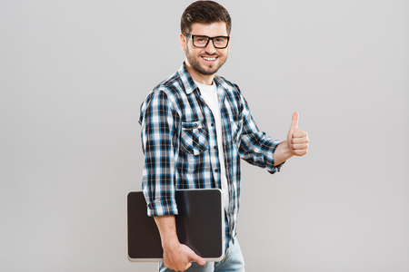 Man holding tablet and showing thumbs-upの写真素材