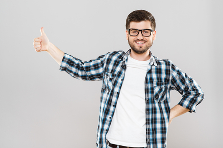 Young man showing thumbs-upの写真素材