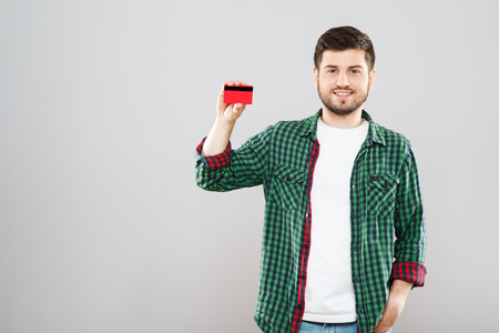 Man holding red credit cardの写真素材