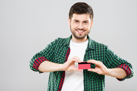 Boy holding red credit cardの写真素材