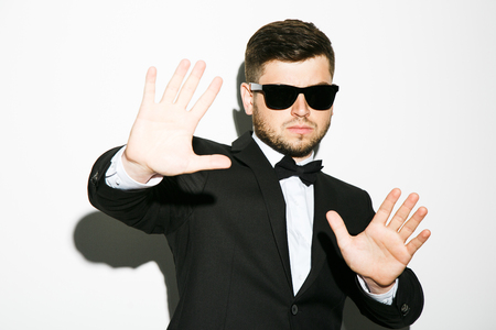 Attractive man in black suit and sunglassesの写真素材