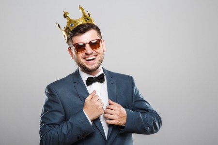 Man in crown laughingの写真素材