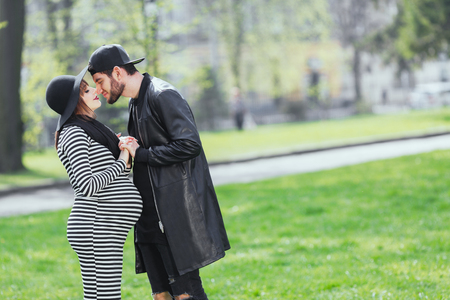 Man and pregnant girl in park