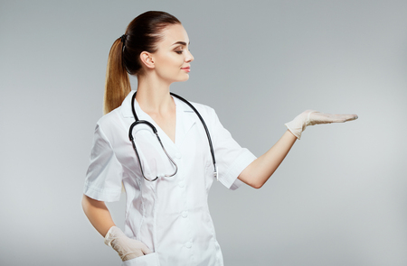Beautiful nurse in white medical robeの写真素材
