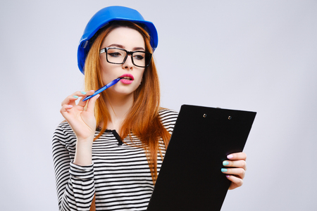 Girl in blue helmet with tabletの写真素材