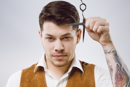 Attractive barber with scissorsの写真素材