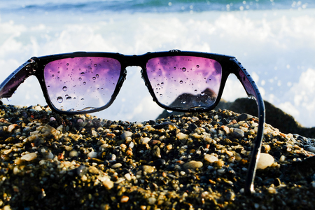 Black sunglasses at sea backgroundの写真素材