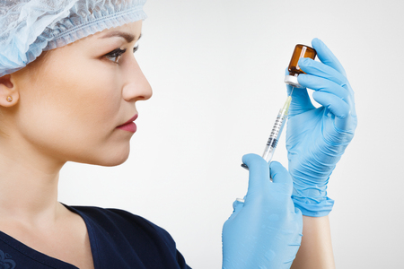 Beautiful nurse in blue medical uniformの写真素材