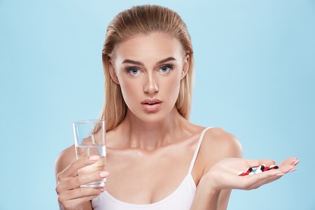 Young girl posing with pillsの写真素材