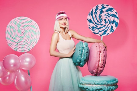 Blonde girl posing with sweetsの写真素材