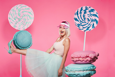 Pretty girl posing with huge lollypopsの写真素材