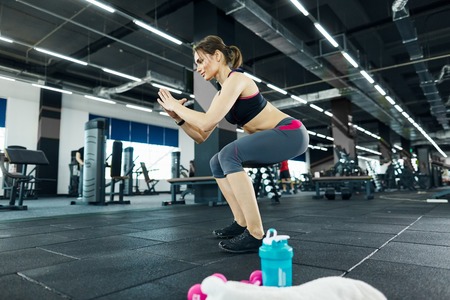 Cute girl exercising in gymの写真素材