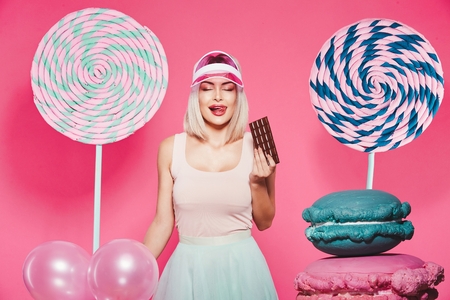 Pretty girl posing with huge lollypopsの写真素材