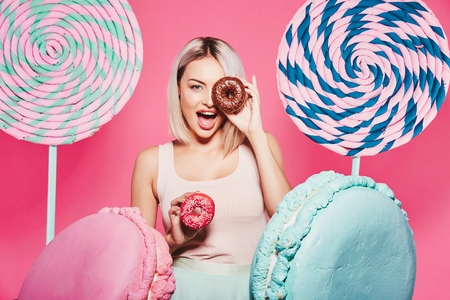 Pretty girl posing with huge lollypopsの写真素材
