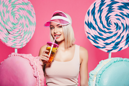 Blonde girl posing with sweetsの写真素材