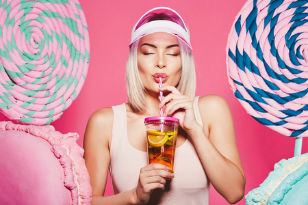 Pretty girl posing with huge lollypopsの写真素材