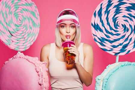 Pretty girl posing with huge lollypopsの写真素材