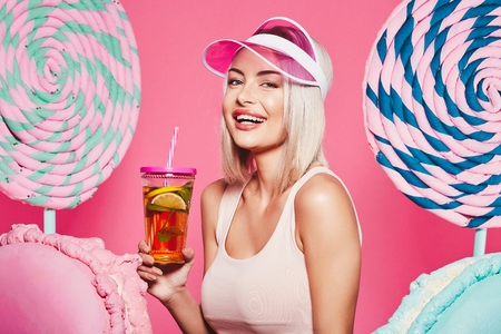 Blonde girl posing with sweetsの写真素材