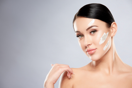 Pretty girl with white clay on faceの写真素材