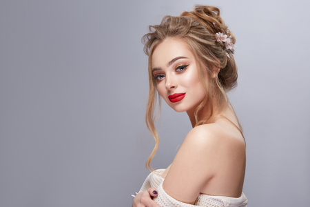nice blond in profile with flowered hairstyle looking to the cameraの写真素材