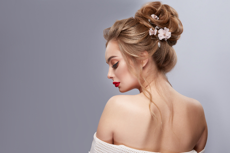 womans back with opened shoulders and perfect flowered hairstyleの写真素材