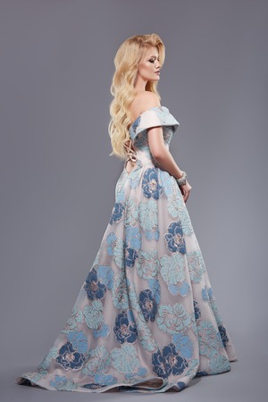profile portrait of full body woman in long and lush evening dressの写真素材
