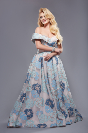 pretty girl in long dress with open shoulders and wavy hairの写真素材