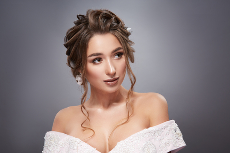 cute girl looking sideways on greyの写真素材