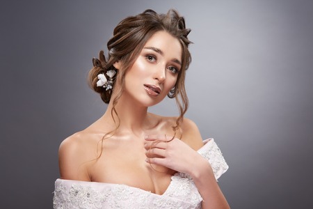 woman with flowers in the hair touching her breastの写真素材