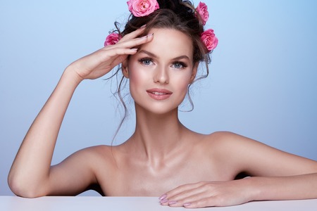 Pretty woman at  studio background with flowersの写真素材
