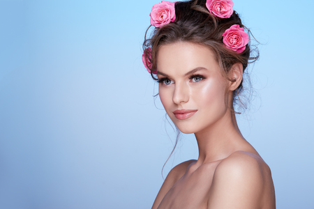 Pretty woman at  studio background with flowersの写真素材