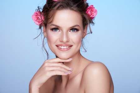 Pretty woman at  studio background with flowersの写真素材