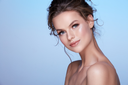 Gorgeous woman at blue studio backgroundの写真素材