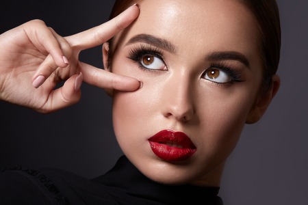 Brunette girl with red lipsの写真素材