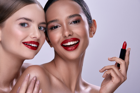 Models posing with lipstickの写真素材