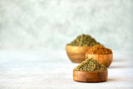 Mixed spice zaatar or zatar in wooden bowls, Various type of zaatar blend. Close up with copy spaceの写真素材