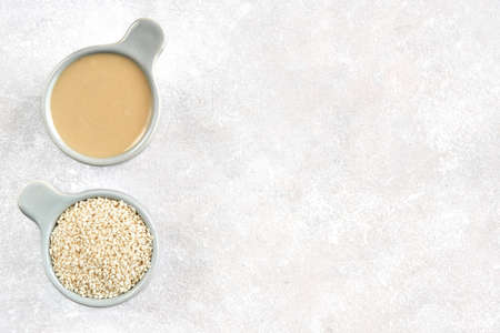 Ceramic bowl with tahini and white sesame seedsの写真素材