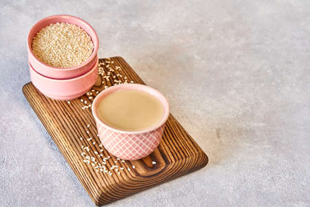 Ceramic bowl with tahini. Close up with copy space