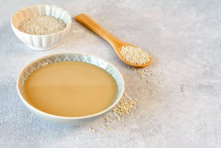 Ceramic bowl with tahini. Close up with copy spaceの写真素材