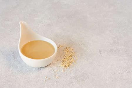 Ceramic bowl with tahini and white sesame seedsの写真素材