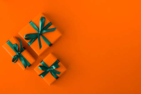 Gift present boxes on orange background. Flat lay. Top view with space for text
