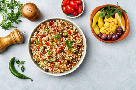 Bulgur pilaf with eggplant and vegetables. Top view with copy spaceの写真素材