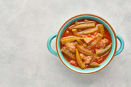 Homemade okra and meat stew in a pot. Top view, copy spaceの写真素材