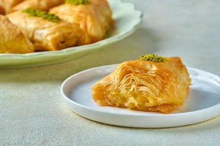 Sweets arabic dessert baklava,, kunafa, kadayif with pistachio nuts and cheese. Closeup