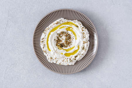 Labneh yogurt, cream cheese with olive oil and zaatar. Traditional middle eastern arabic breakfast dip.Top viewの写真素材