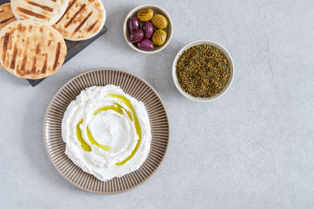 Labneh yogurt, cream cheese with olive oil and zaatar. Traditional middle eastern arabic breakfast dip.Top view with copy spaceの写真素材
